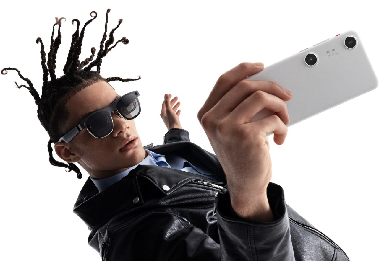 A model wearing XREAL Air 2 Pro smart glasses while using an XREAL Beam Pro to capture photos.