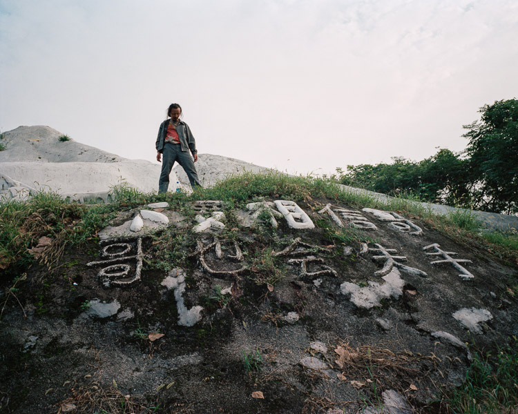 Xiao Zhi on the top of a artificial hill in Chongqing. Photo via Hua Weicheng.