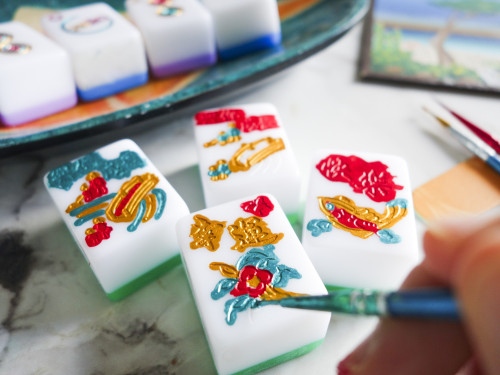 A workshop at the Wereldmuseum in Rotterdam, with participants seated around tables engaging in a cultural activity inside a museum space.