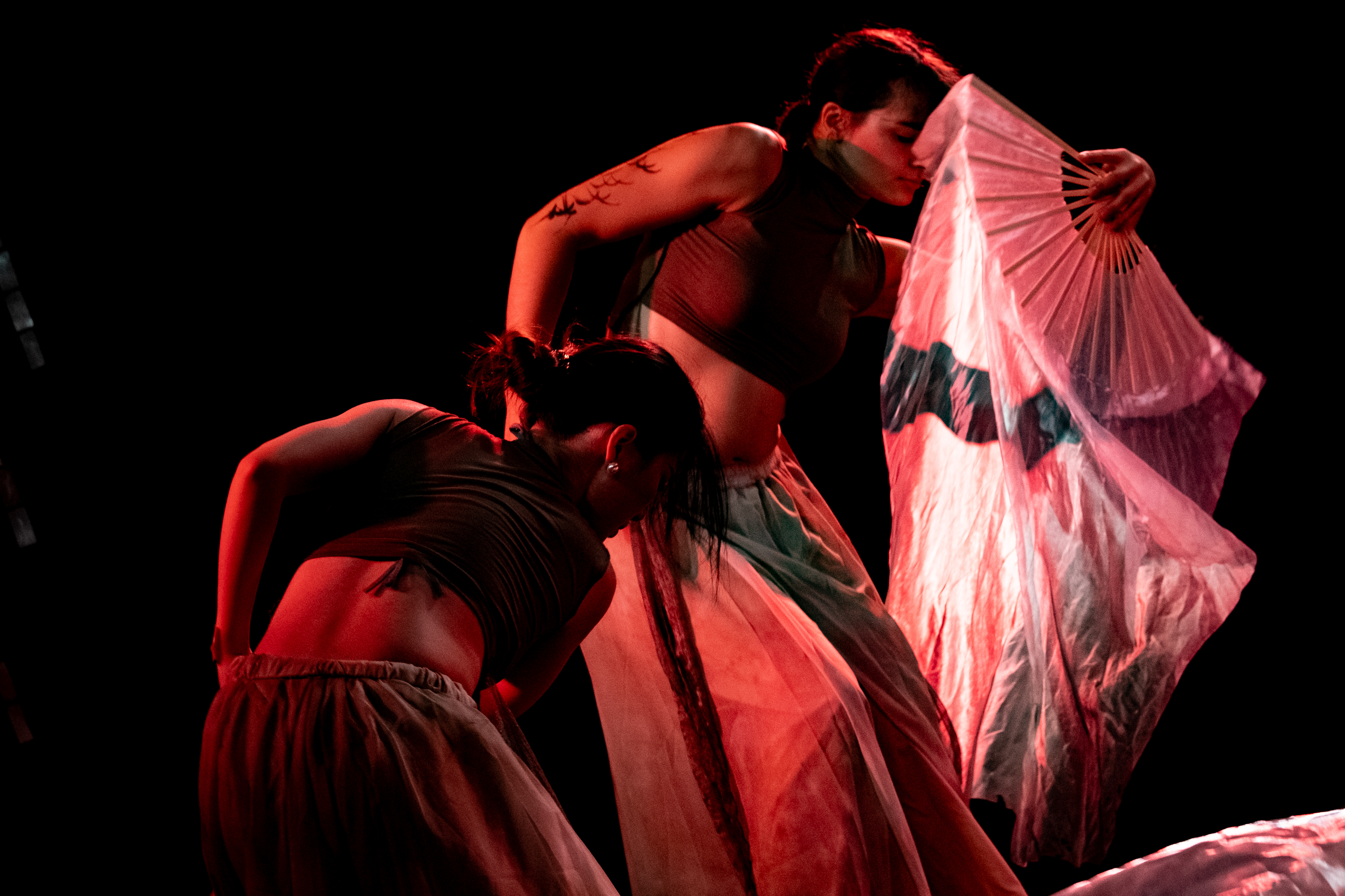 Stage performance scene featuring a solo performer presenting a theatre piece related to nüshu in Edinburgh.