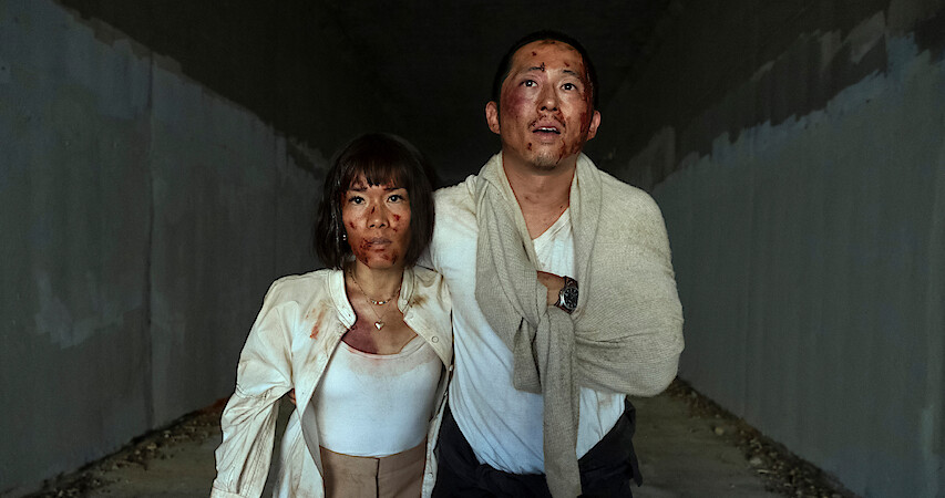 Amy and Danny holding hands trying to get out of the cave, screenshots from Season 1 of beef.